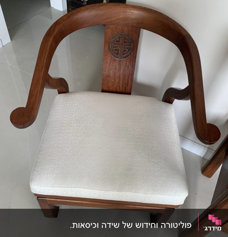 כיסא עץ עם ריפוד בהיר ודוגמה מעוגלת בגב